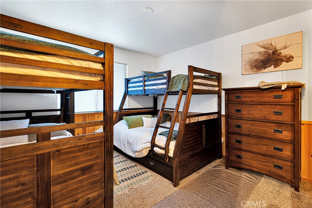 42363 Paramount Road Big Bear Lake, CA 92315 - Photo 27 of 58 a bedroom with a bed and wooden floor