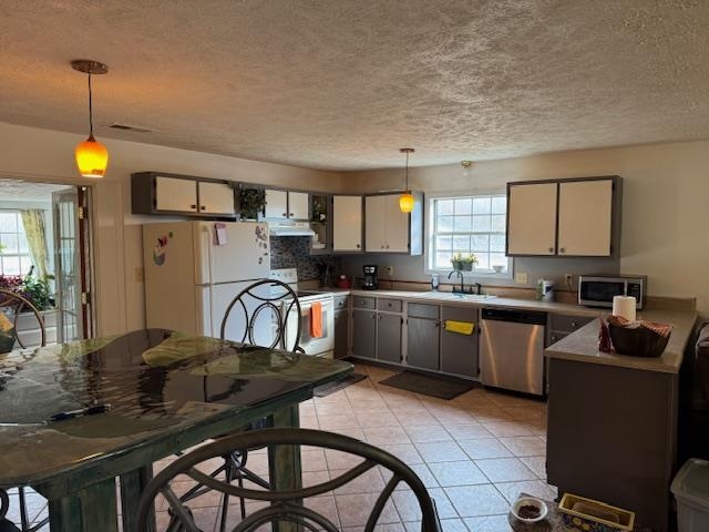 275 Fritton Spur Road Middleton, TN 38052 - Photo 8 of 23 a kitchen with granite countertop a table chairs a sink dishwasher window and cabinets