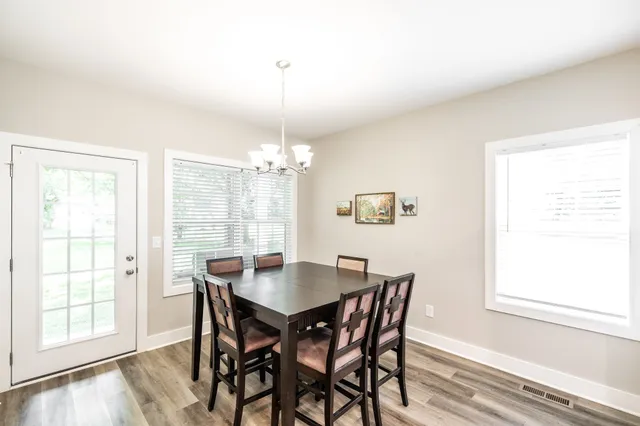a view of a dining room with furniture wooden floor and chandelier