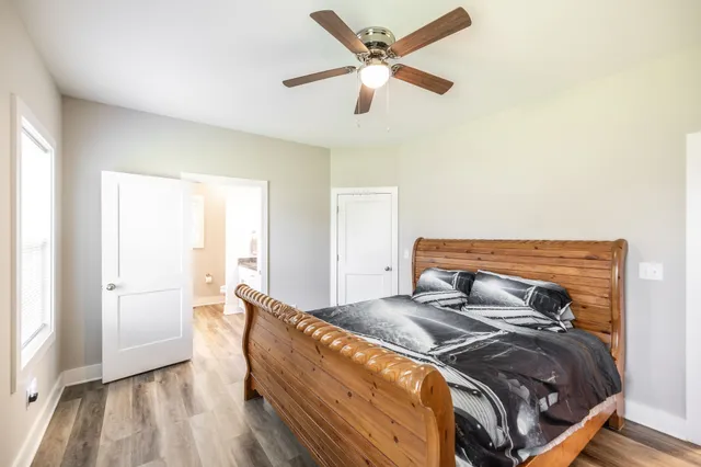 a bedroom with a bed and a window