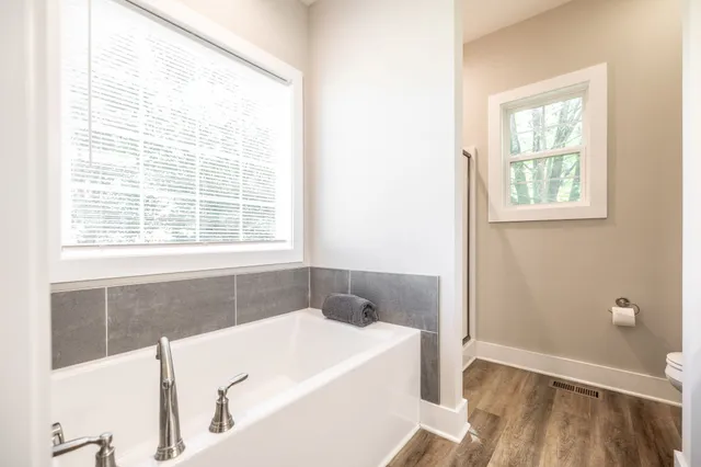 a white bath tub sitting next to a window