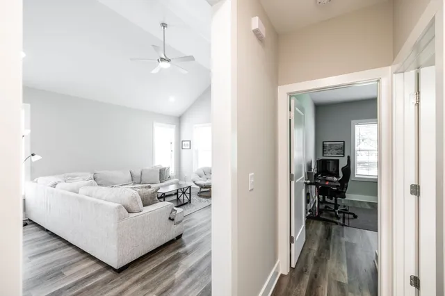 a living room with furniture and a view of bathroom