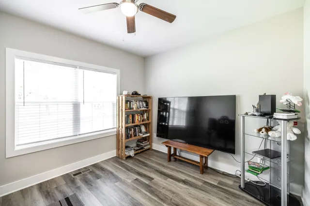 an empty room with windows and flat screen tv