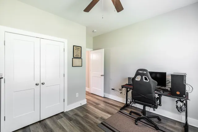 a view of a workspace with furniture and a window