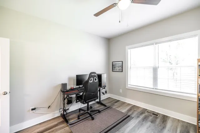 a view of workspace with wooden floor windows