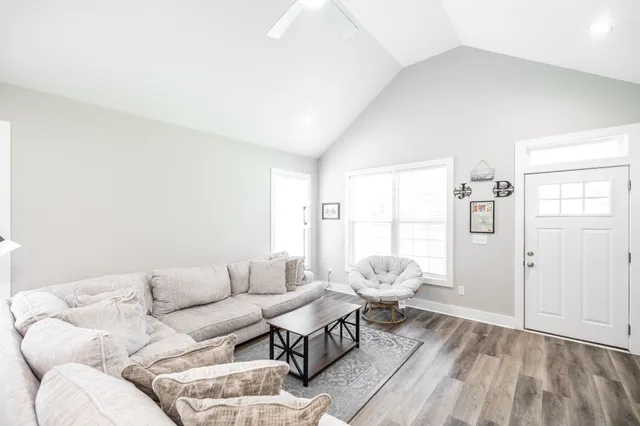 a living room with furniture and wooden floor