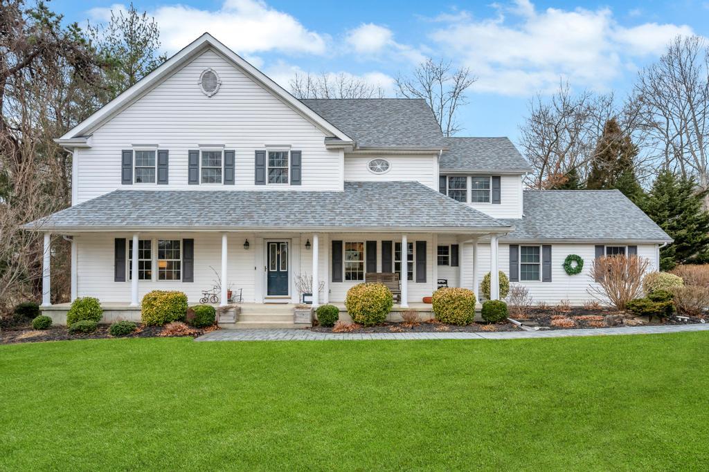 a front view of a house with garden and porch
