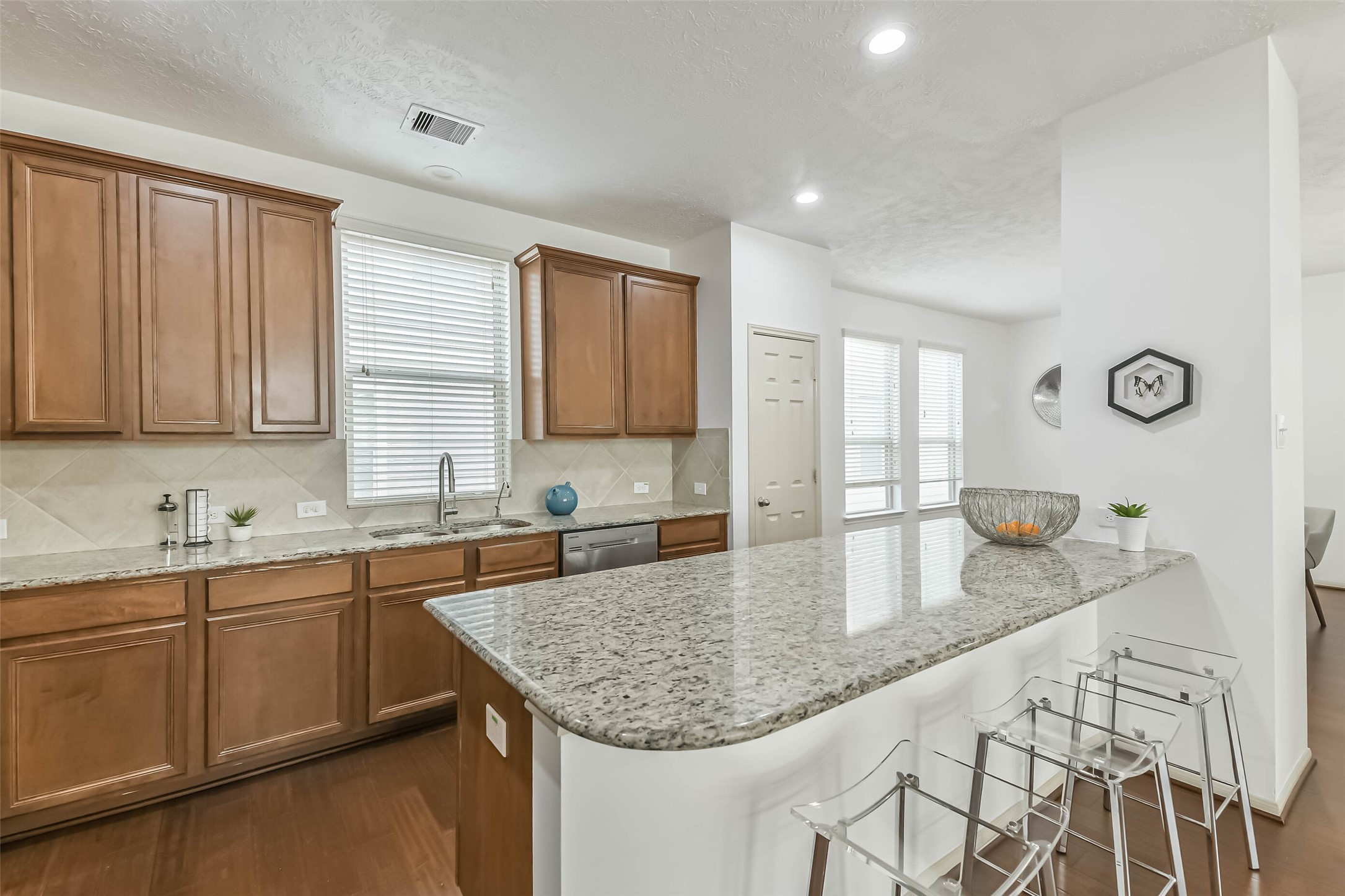 3324 Masters Point Drive Houston, TX 77091 - Photo 15 of 40 a kitchen with granite countertop a sink a stove cabinets and counter space