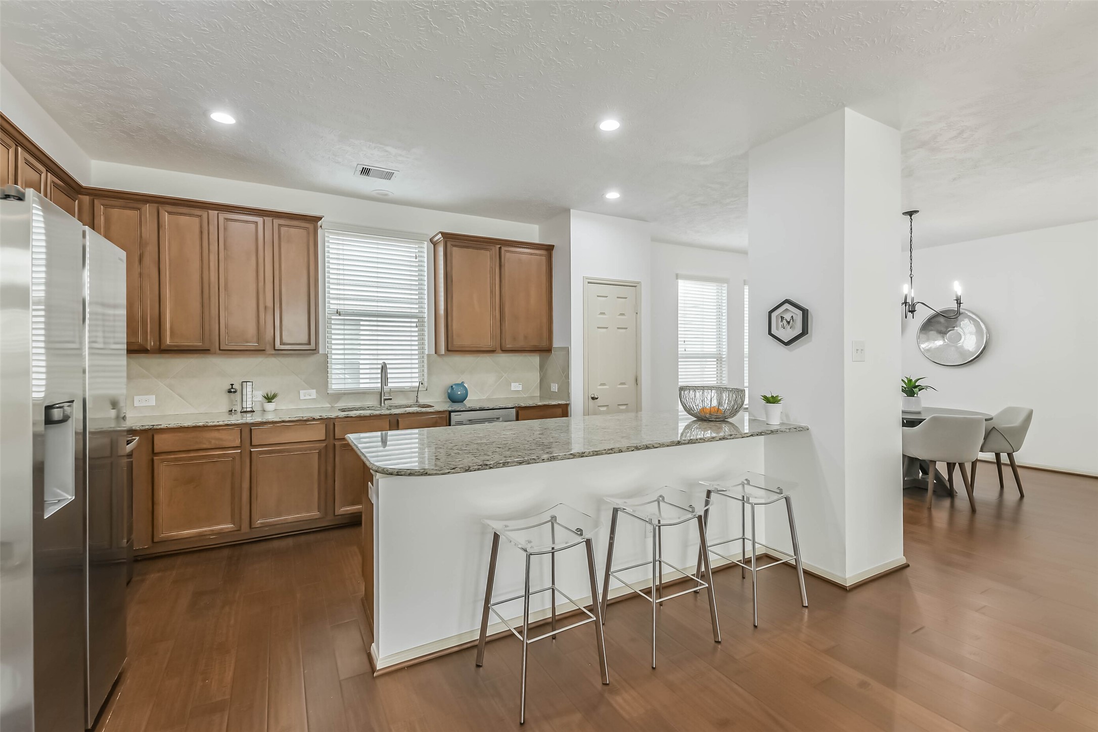 3324 Masters Point Drive Houston, TX 77091 - Photo 16 of 40 a large kitchen with cabinets chairs and wooden floor