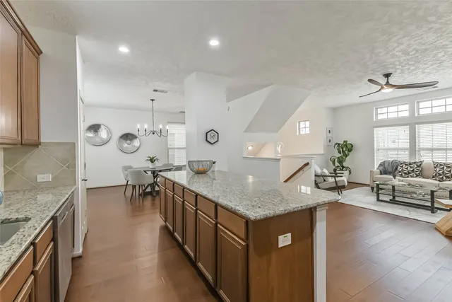a kitchen with stainless steel appliances granite countertop a sink dishwasher stove and oven