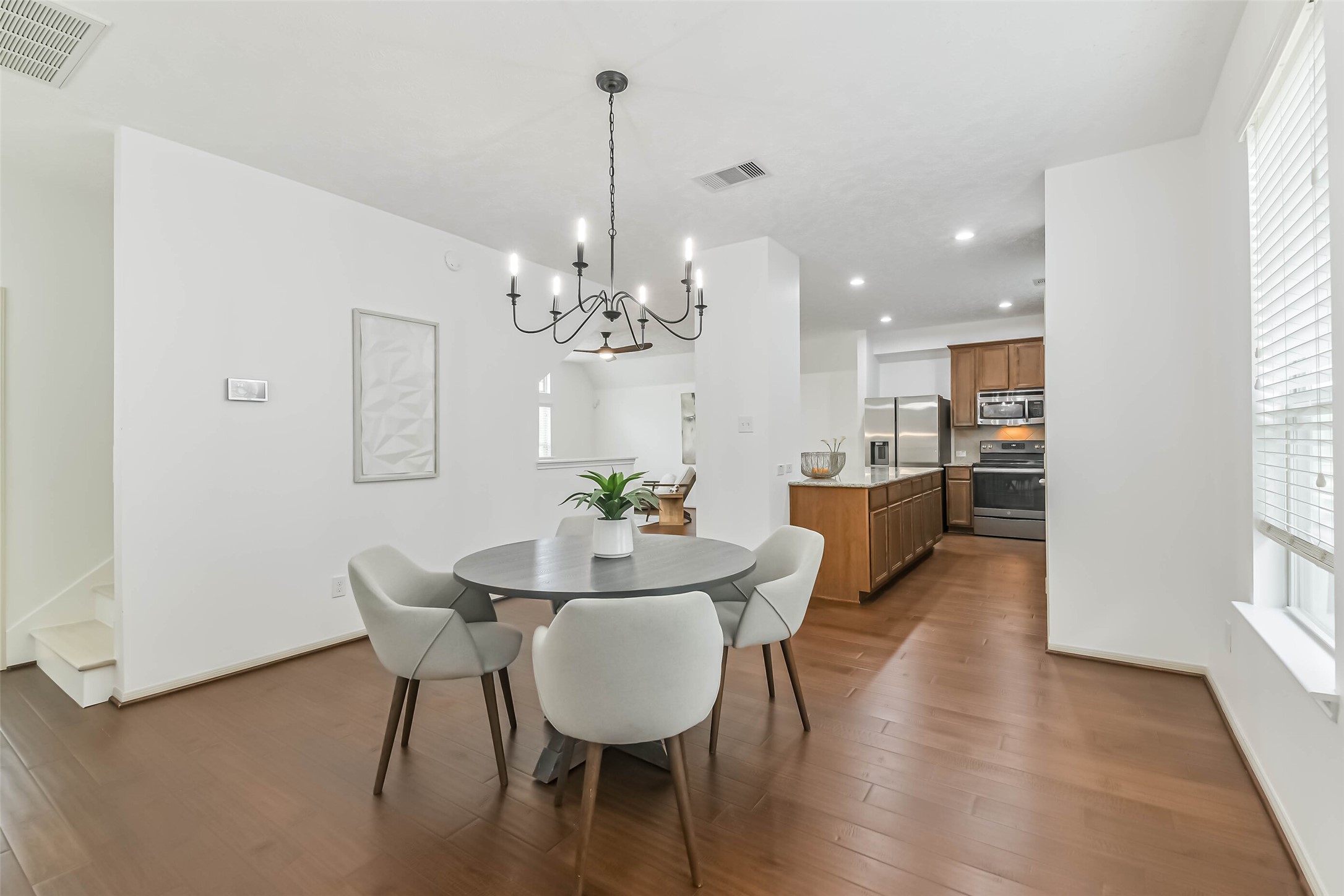 3324 Masters Point Drive Houston, TX 77091 - Photo 23 of 40 a view of a dining room with furniture wooden floor and chandelier