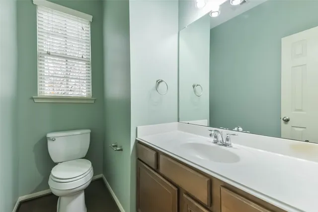 a bathroom with a sink toilet and a mirror
