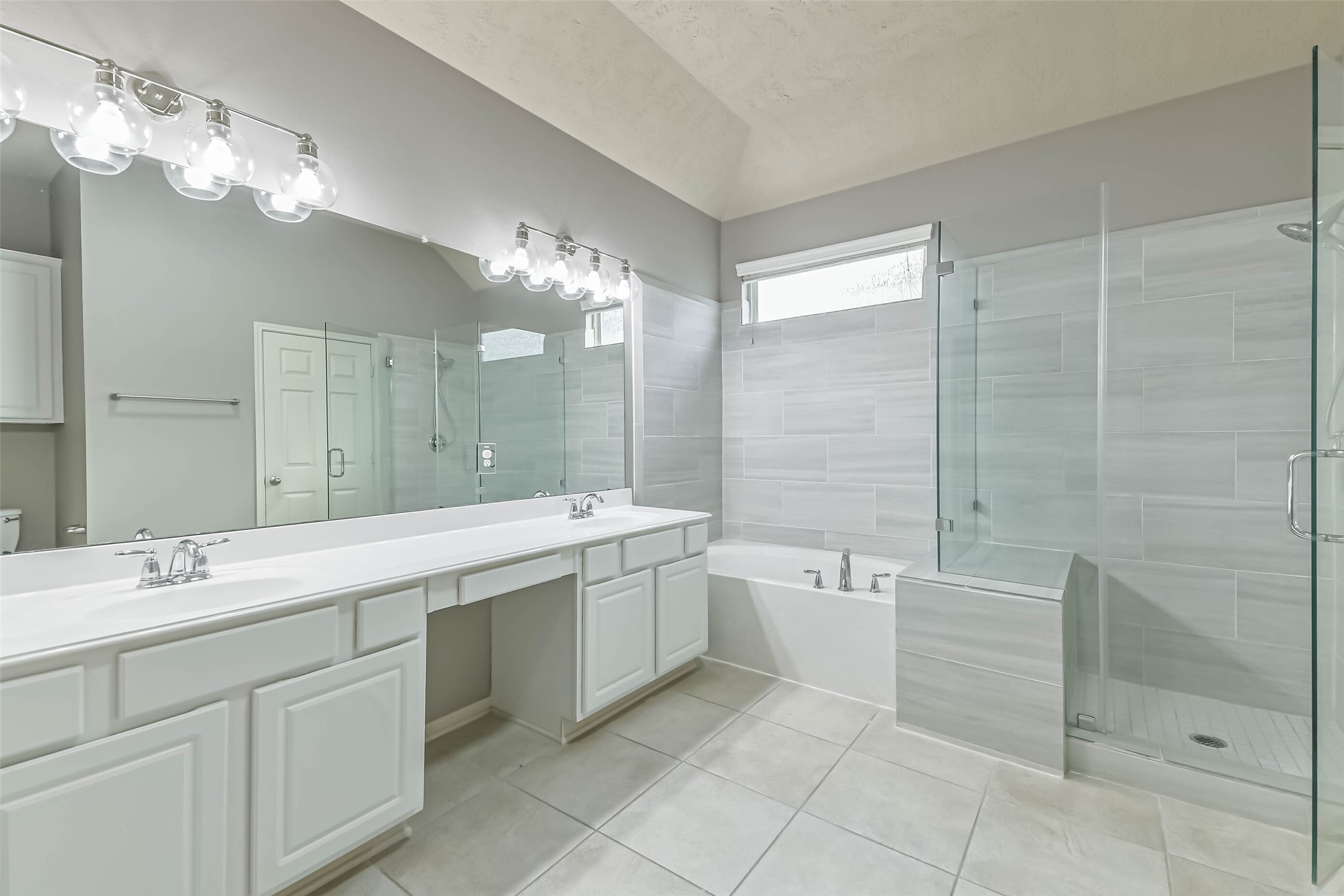 3324 Masters Point Drive Houston, TX 77091 - Photo 28 of 40 a spacious bathroom with a double vanity sink a large mirror and a bathtub