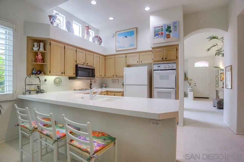 793 Poppy Road San Marcos, CA 92078 - Photo 13 of 38 a kitchen with stainless steel appliances a sink and a refrigerator