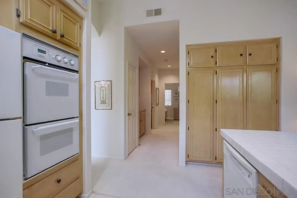 793 Poppy Road San Marcos, CA 92078 - Photo 18 of 38 a view of a kitchen cabinets and wooden floor