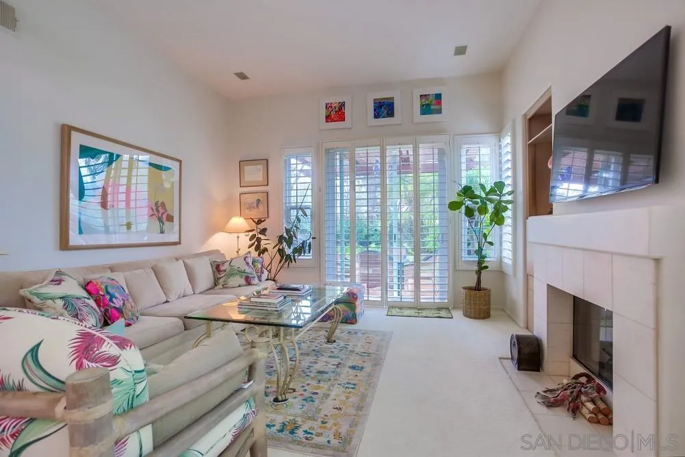 793 Poppy Road San Marcos, CA 92078 - Photo 6 of 38 a living room with furniture potted plant and a fireplace