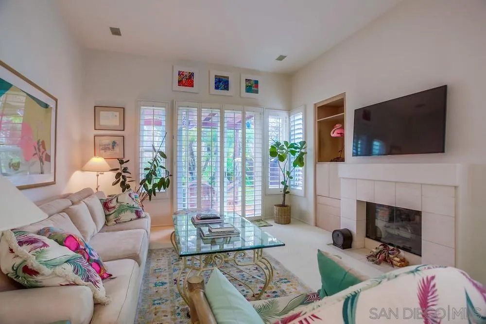 793 Poppy Road San Marcos, CA 92078 - Photo 8 of 38 a living room with furniture a flat screen tv and a fireplace