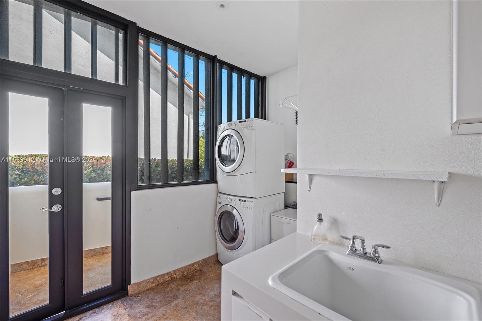 422 Fernwood Road, Unit 422 Key Biscayne, FL 33149 - Photo 14 of 25 a bathroom with a sink and a washing machine