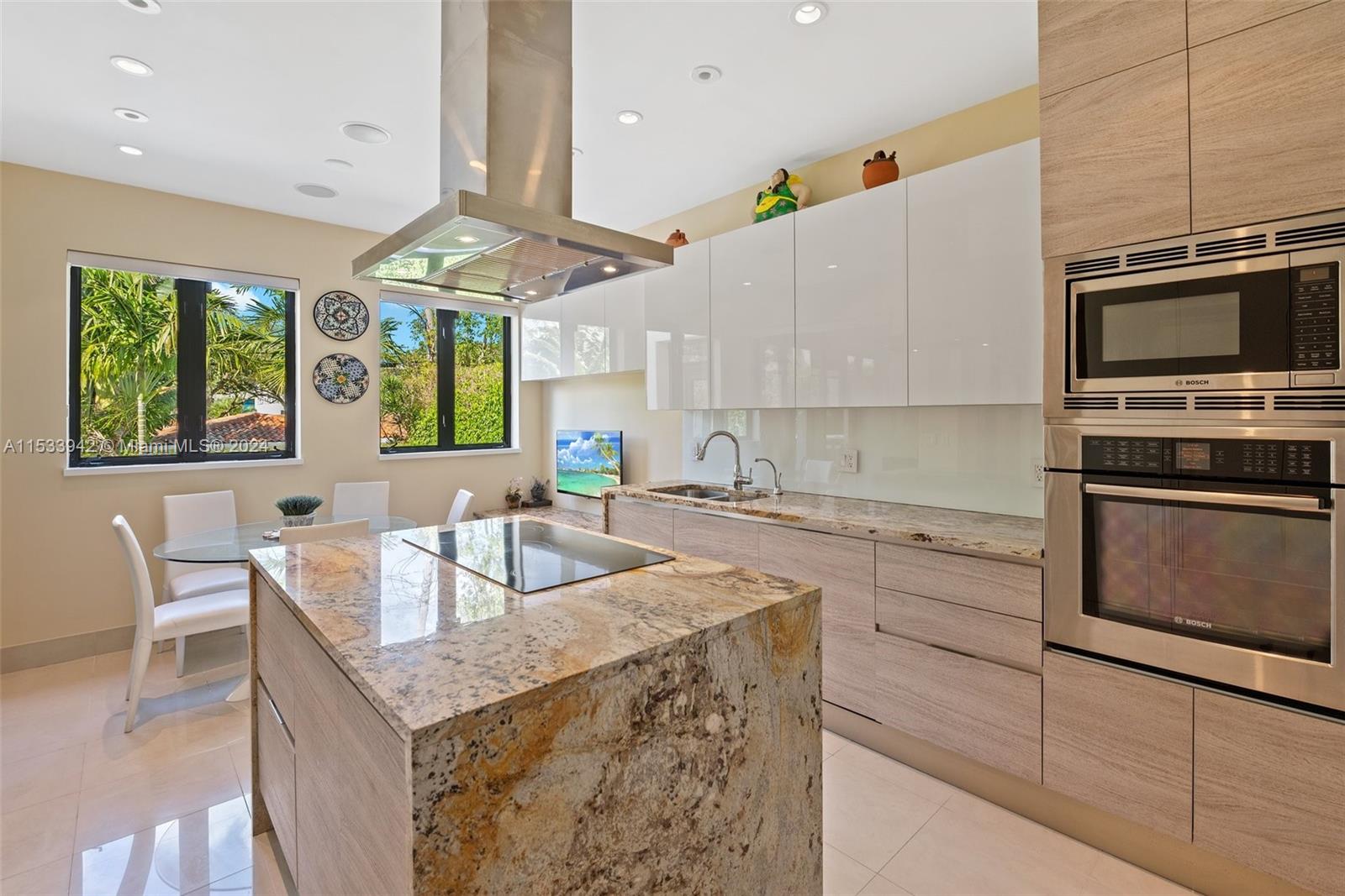 422 Fernwood Road, Unit 422 Key Biscayne, FL 33149 - Photo 8 of 25 a kitchen with granite countertop a sink stainless steel appliances and furniture