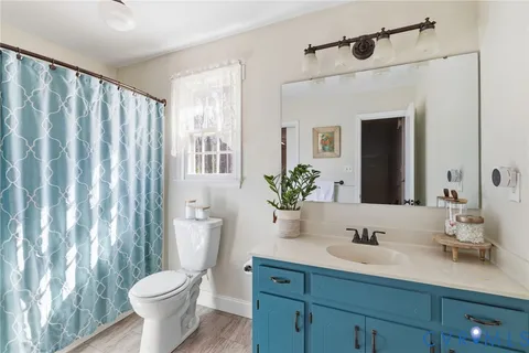 a bathroom with a toilet a sink and a mirror