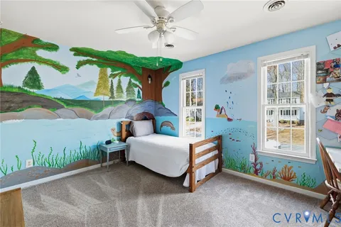 a bedroom with furniture and a window