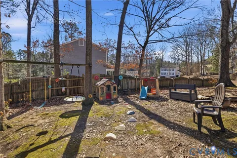 a view of a chairs and bench in the backyard