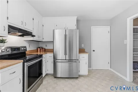 a kitchen with stainless steel appliances granite countertop a refrigerator a stove a microwave and cabinets