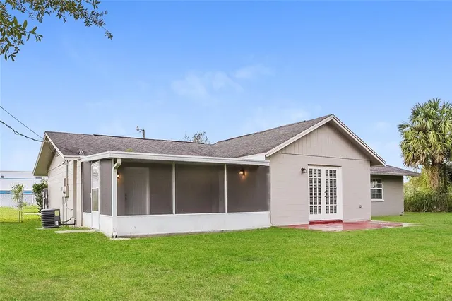 a view of a house with a yard and pathway