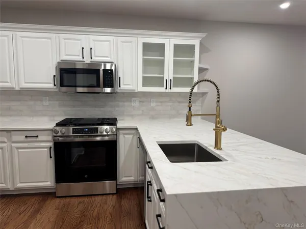 a kitchen with stainless steel appliances granite countertop a stove and a sink