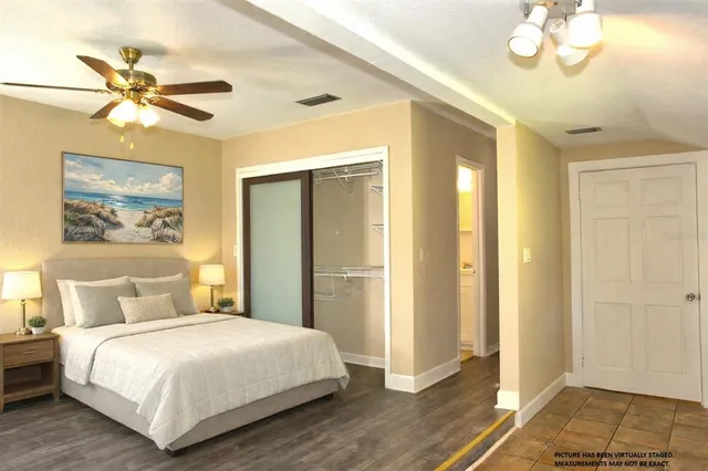 a view of a workspace room with wooden floor table and chair