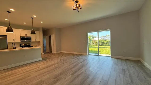 a view of kitchen with cabinets and wooden floor