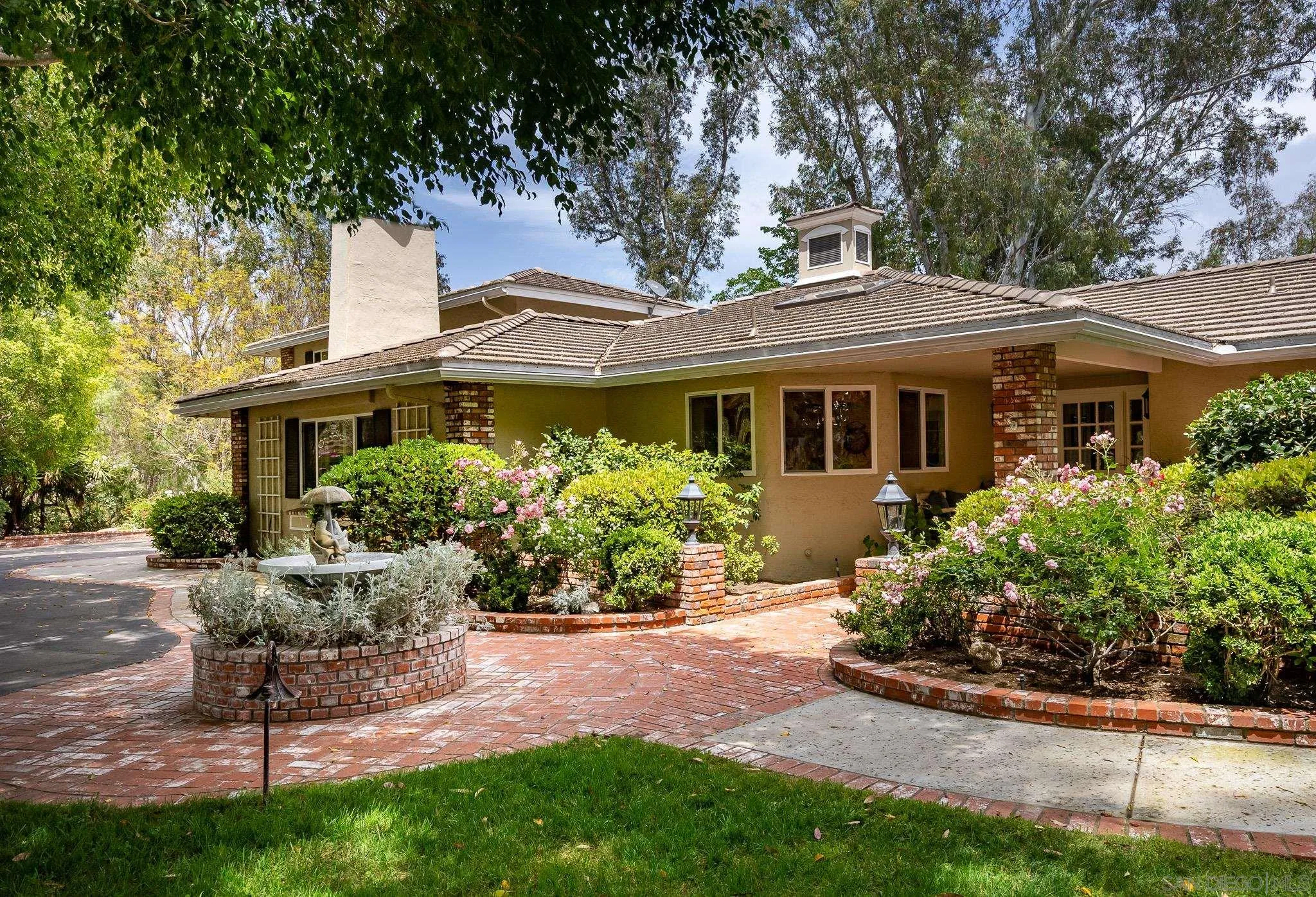 17509 Rancho Del Rio Rancho Santa Fe, CA 92067 - Photo 31 of 67 a front view of a house with a yard and porch