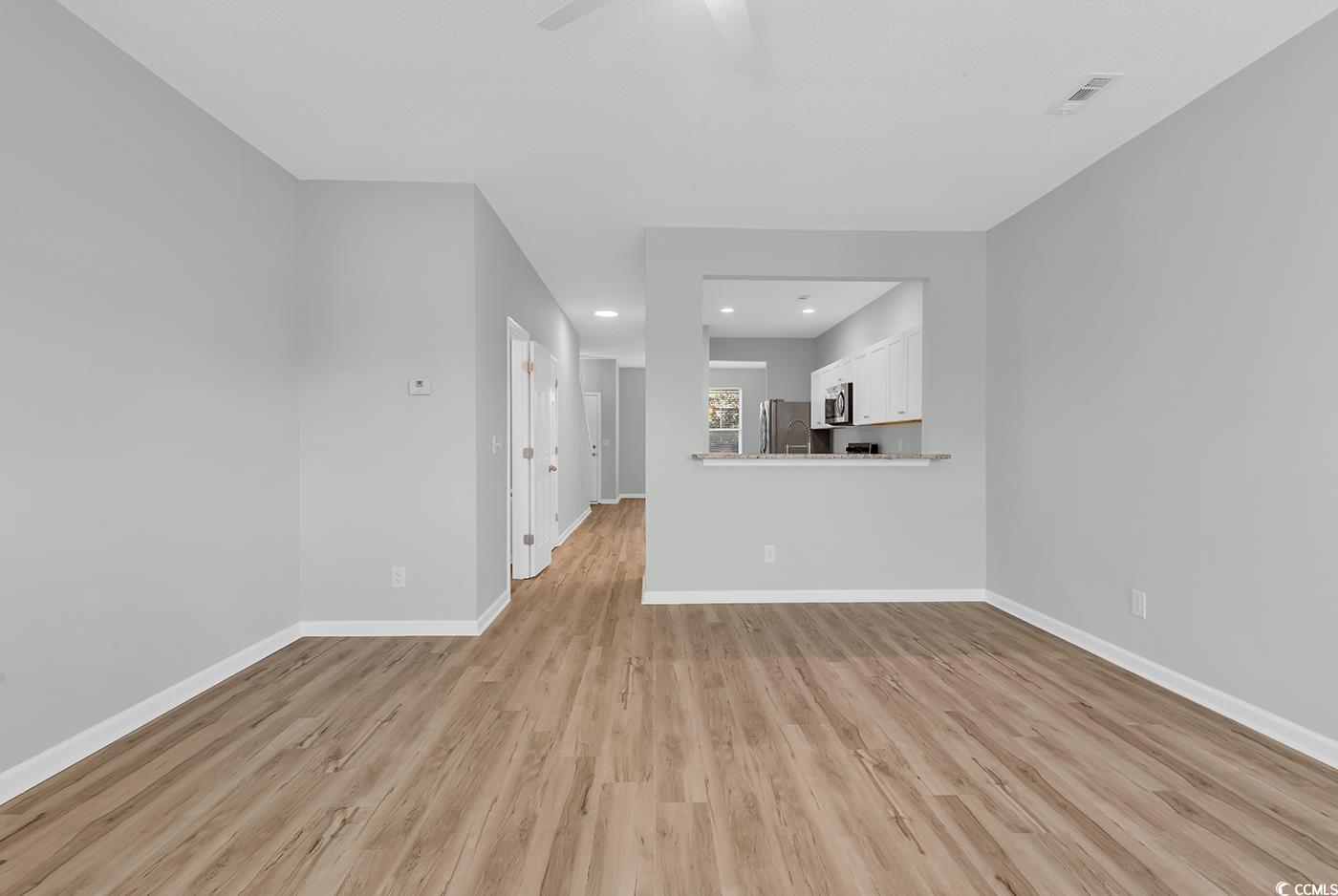 308 Kiskadee Loop, Unit E Conway, SC 29526 - Photo 14 of 36 Unfurnished living room with light wood-type flooring and recessed lighting