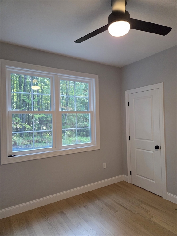 65 Adams Road Townsend, MA 01469 - Photo 15 of 18 a view of an empty room with wooden floor and a window