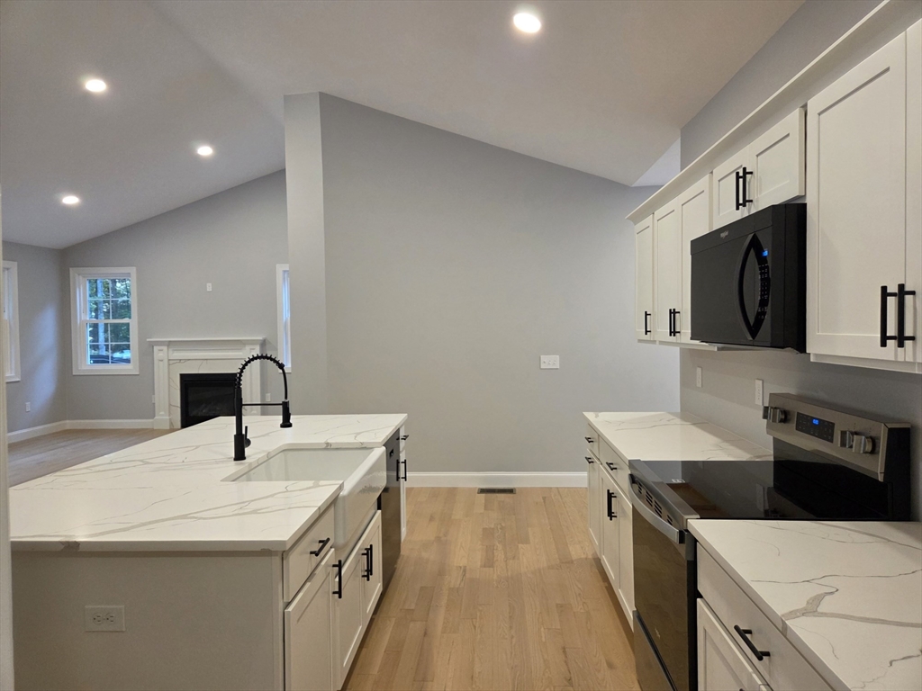 65 Adams Road Townsend, MA 01469 - Photo 2 of 18 a kitchen with a sink stove and microwave
