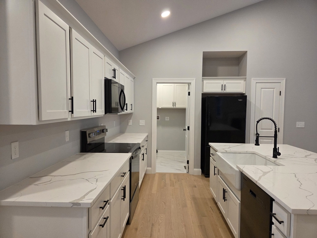 65 Adams Road Townsend, MA 01469 - Photo 3 of 18 a kitchen with a sink stove and refrigerator