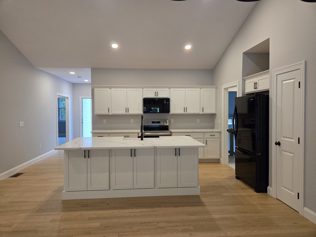 65 Adams Road Townsend, MA 01469 - Photo 4 of 18 a view of kitchen with stainless steel appliances refrigerator stove microwave and cabinets
