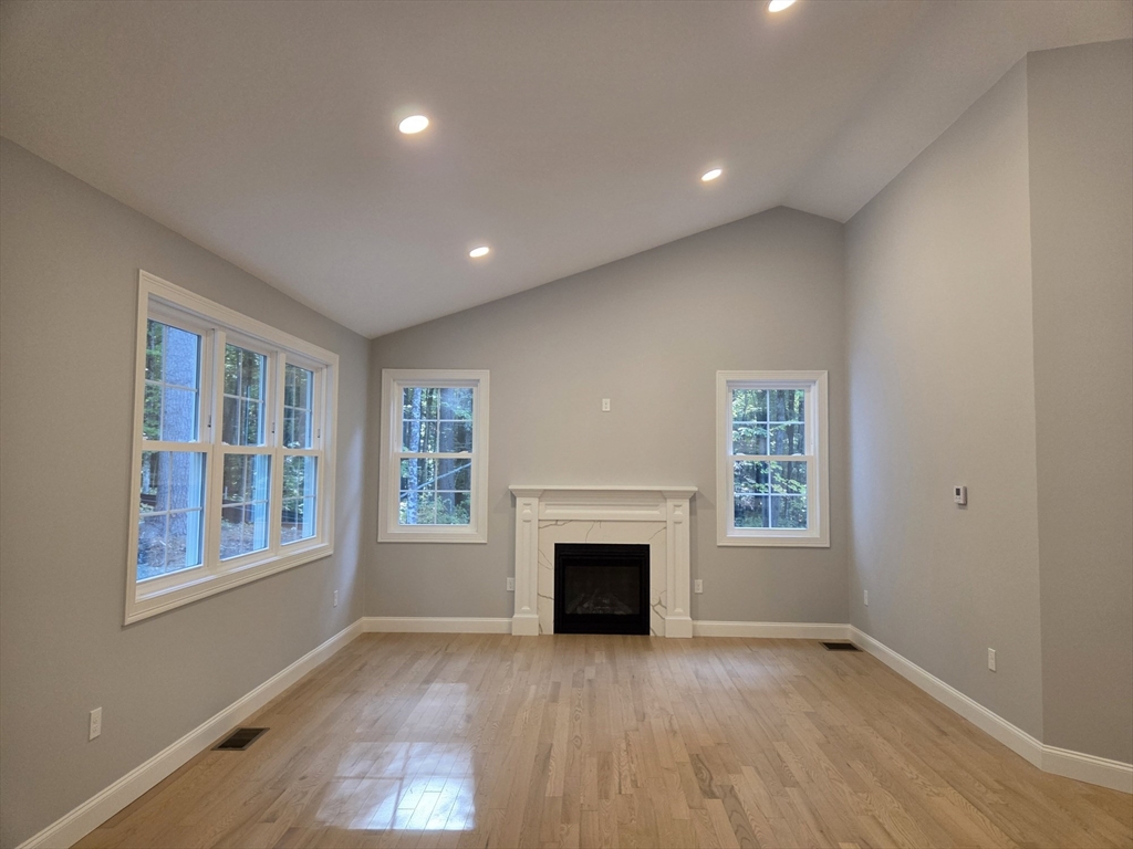65 Adams Road Townsend, MA 01469 - Photo 7 of 18 a view of an empty room with wooden floor and a window