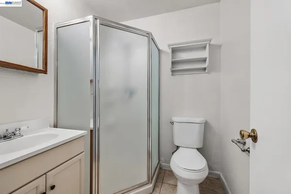 a bathroom with a shower sink and mirror
