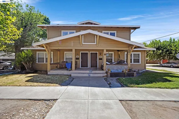 a front view of a house with a garden