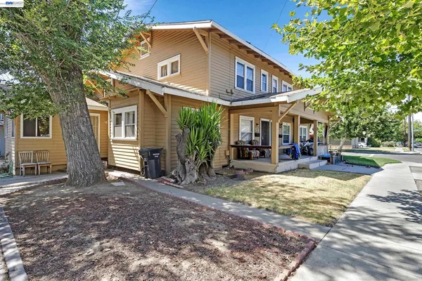a view of a house with backyard porch and sitting area