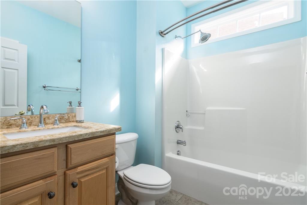 361 Garnet Court Fort Mill, SC 29708 - Photo 19 of 38 a bathroom with a granite countertop sink toilet and shower
