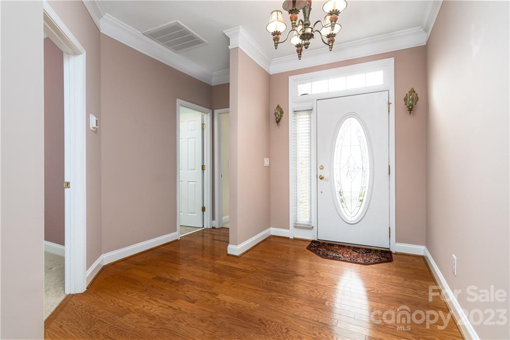 361 Garnet Court Fort Mill, SC 29708 - Photo 3 of 38 a view of a livingroom with wooden floor and mirror