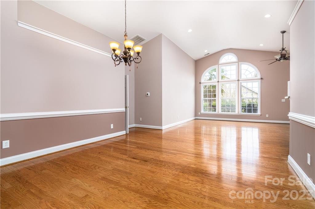 361 Garnet Court Fort Mill, SC 29708 - Photo 4 of 38 a view of an empty room with a window and wooden floor