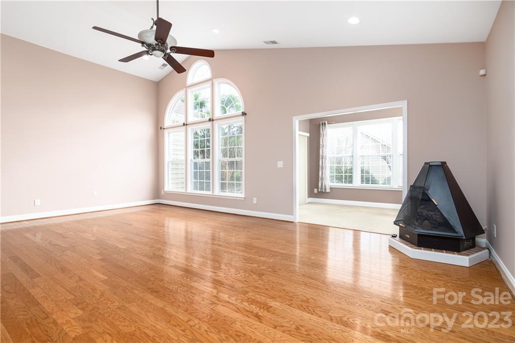361 Garnet Court Fort Mill, SC 29708 - Photo 7 of 38 an empty room with wooden floor fan and windows