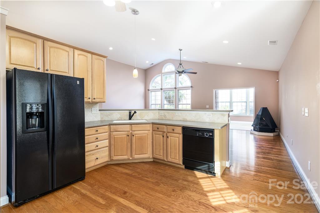 361 Garnet Court Fort Mill, SC 29708 - Photo 10 of 38 a kitchen with stainless steel appliances granite countertop a refrigerator a sink dishwasher a stove and white countertops with wooden floor
