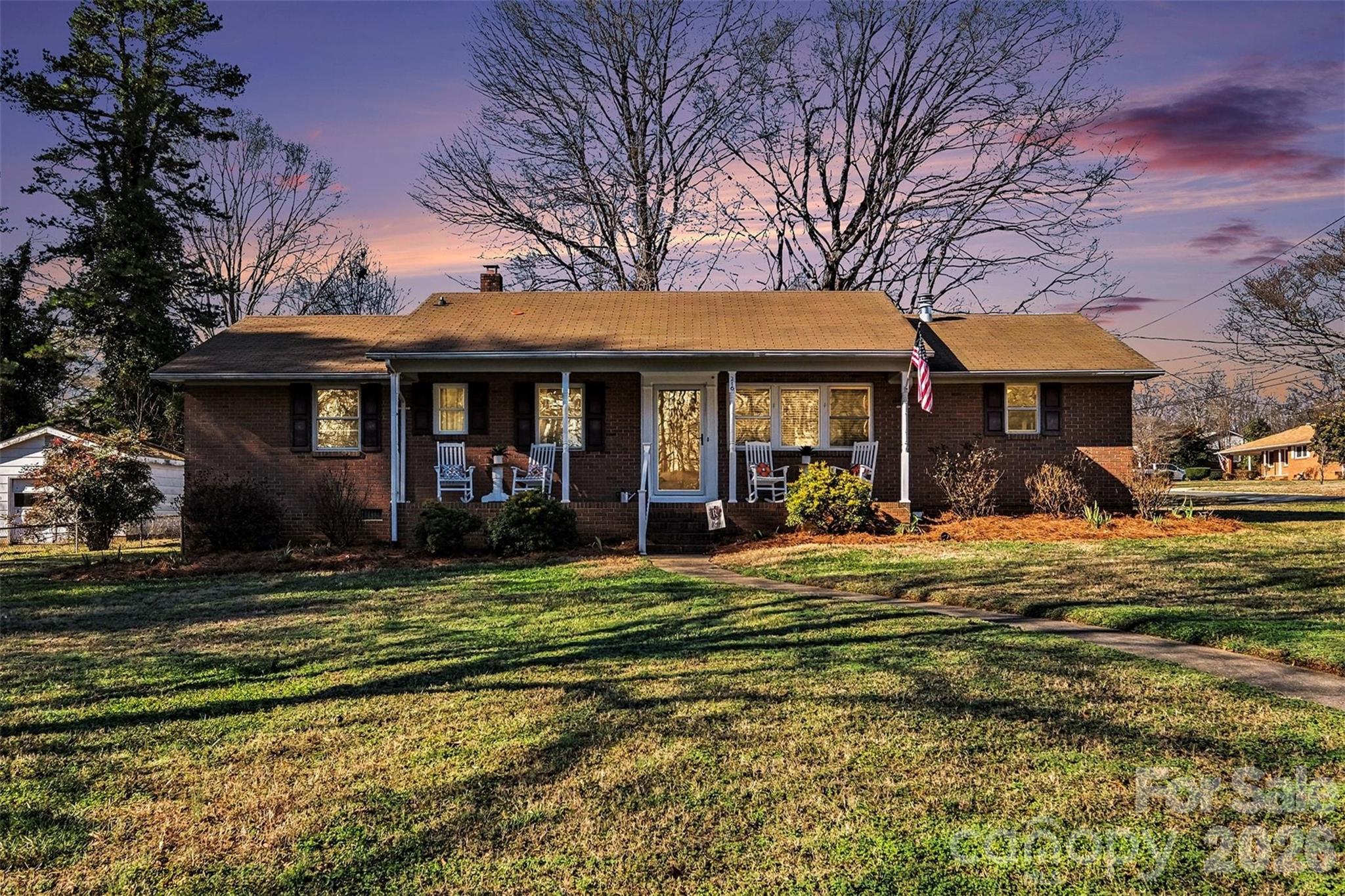 216 Malcolm Road Salisbury, NC 28144 - Photo 1 of 38 a view of a house with a large window and a table and chairs under an umbrella
