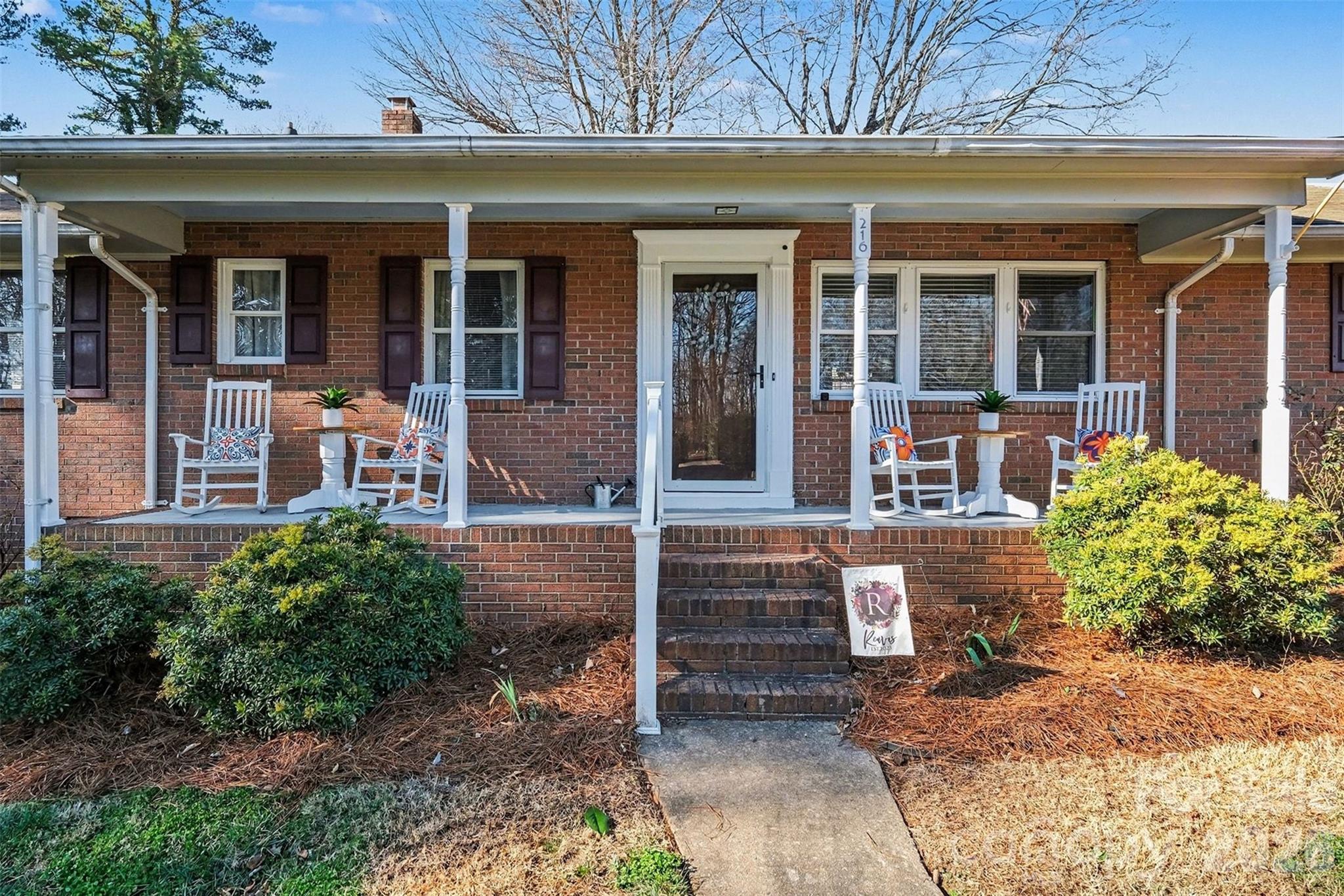 216 Malcolm Road Salisbury, NC 28144 - Photo 2 of 38 front view of the house with a bench
