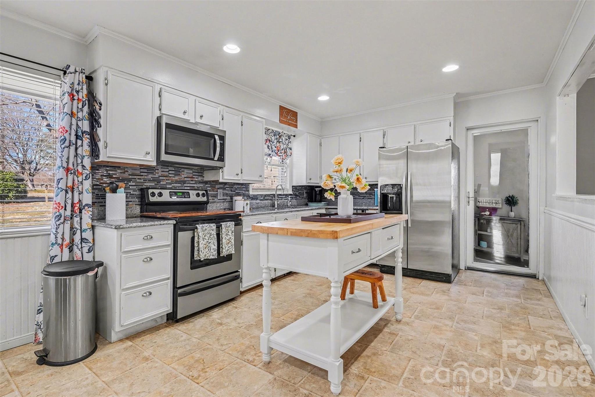 216 Malcolm Road Salisbury, NC 28144 - Photo 4 of 38 a kitchen with white cabinets and stainless steel appliances