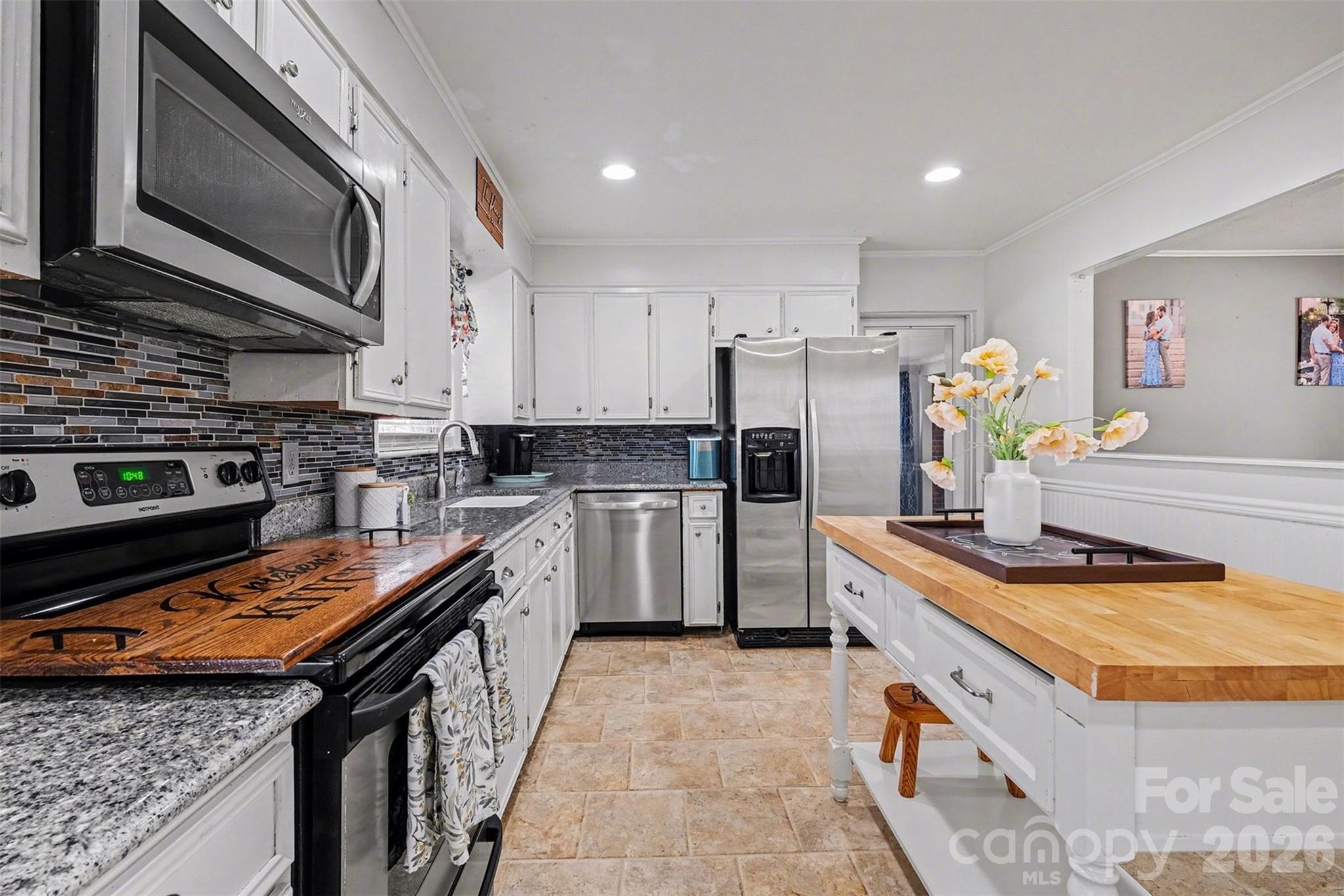 216 Malcolm Road Salisbury, NC 28144 - Photo 5 of 38 a kitchen with stainless steel appliances a stove sink microwave and cabinets